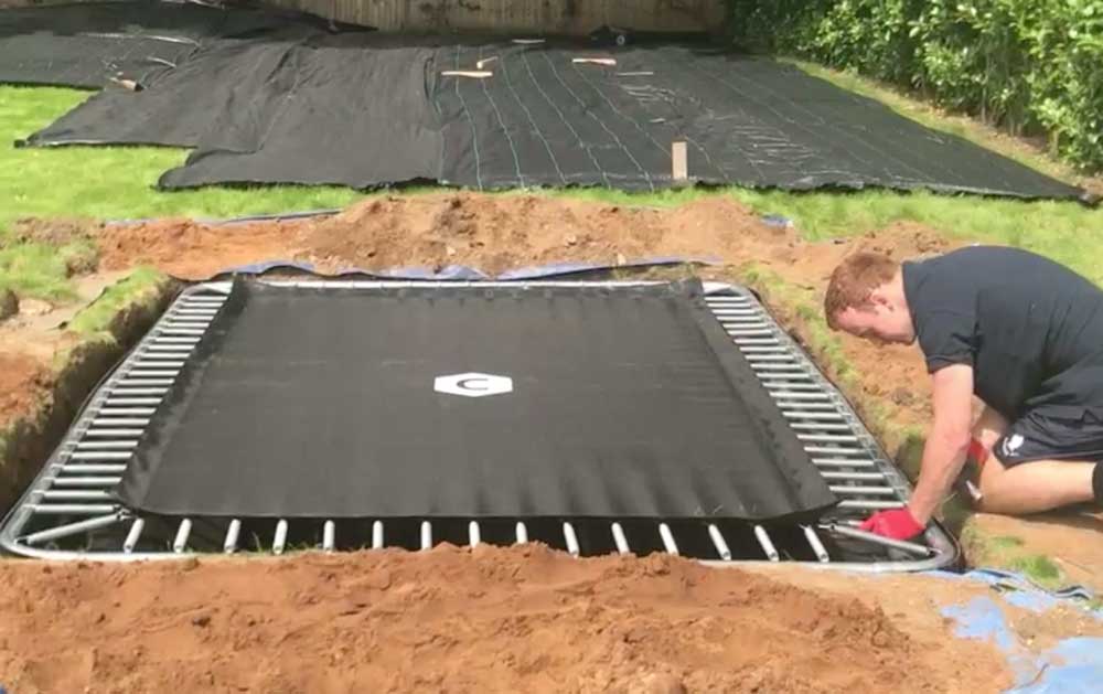 drop the trampoline into the hole