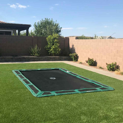in-ground trampoline in backyard