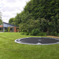 Large 12ft in-ground trampoline in lawn Thumbnail