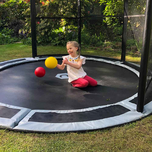 Child on 10ft in-ground trampoline with half net